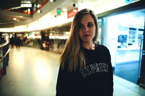 woman wearing black supreme sweater